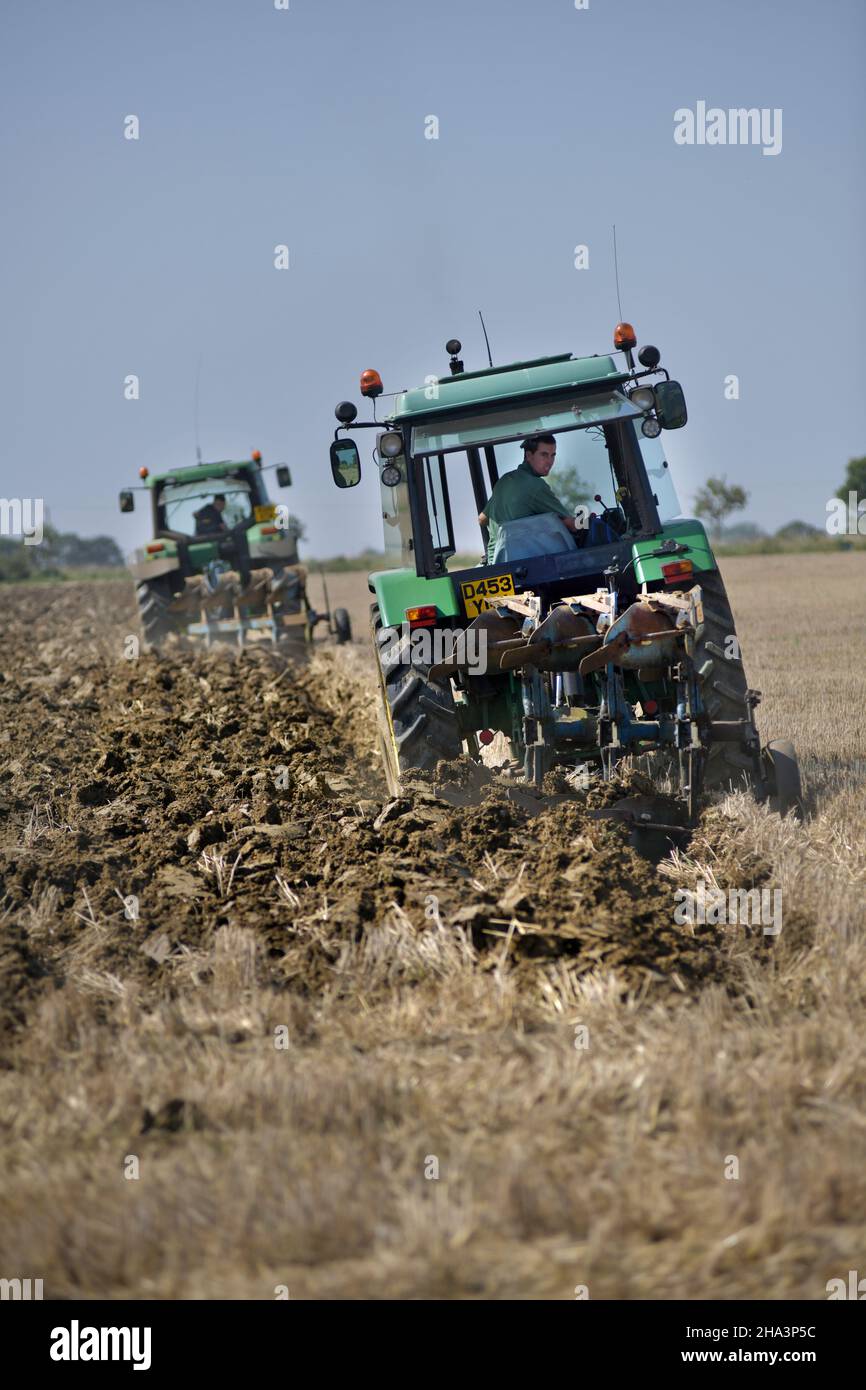 two vintage tractors ploughing at brampton suffolk england Stock Photo