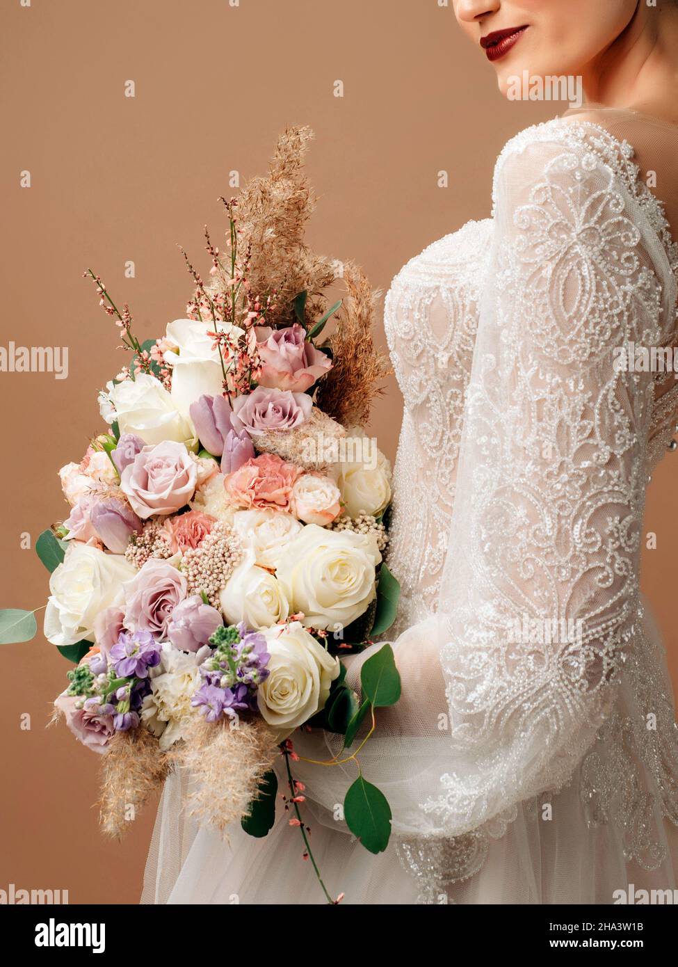 Bride in wedding dress with lush pastel bridal bouquet closeup Stock ...