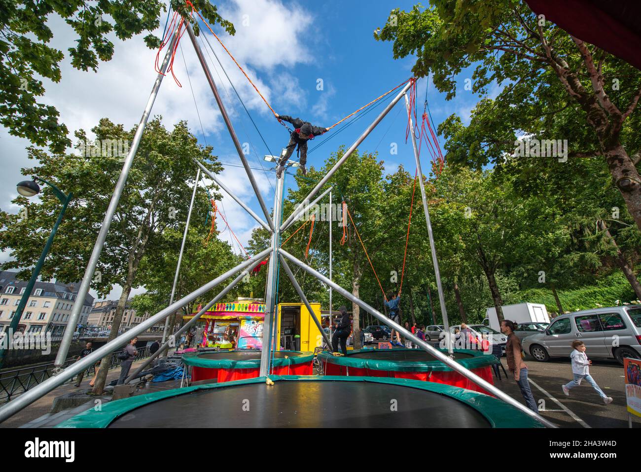 Child on bungee trampoline, Quimper, Brittany, France Stock Photo - Alamy