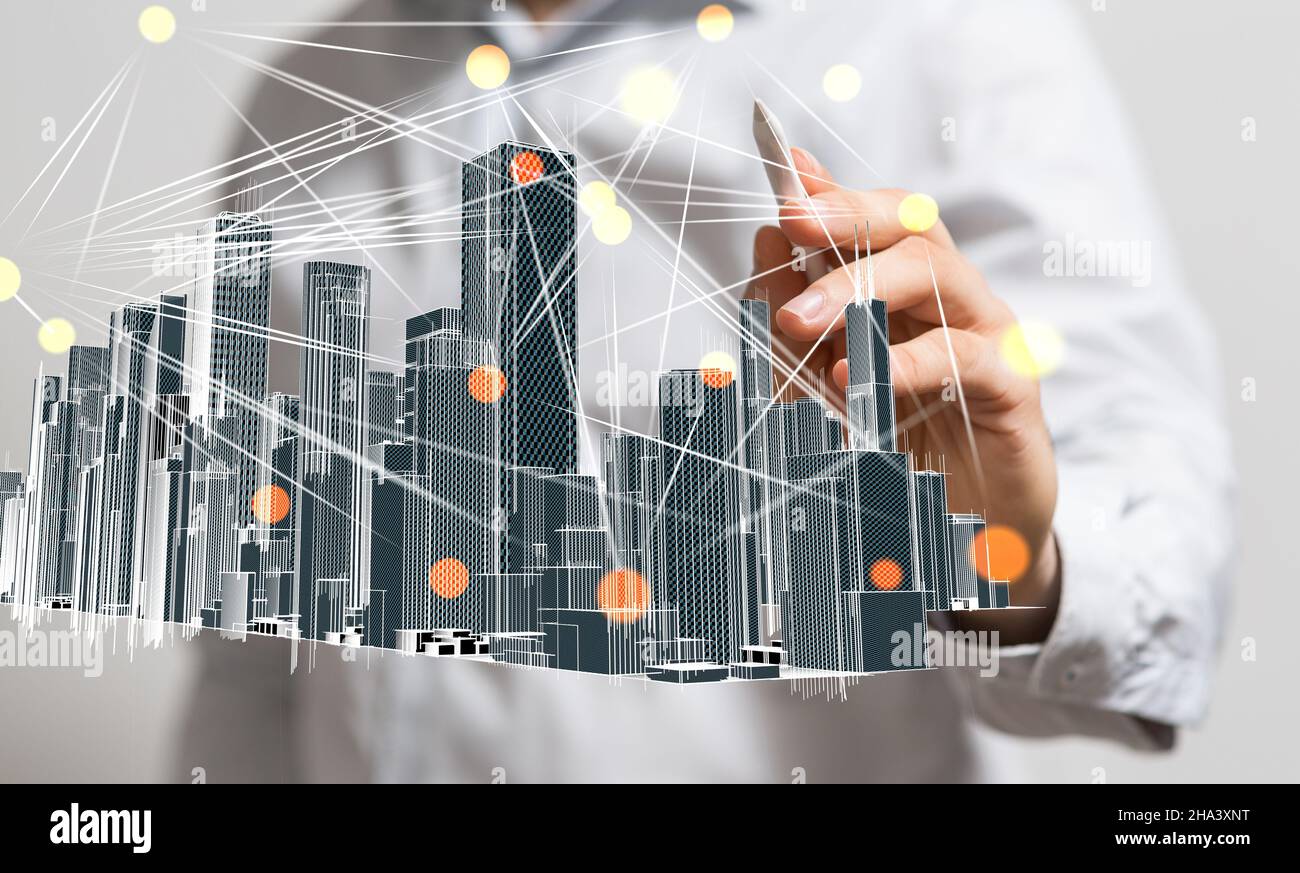 Businessman hovering a modern cityscape floating on his hand Stock Photo