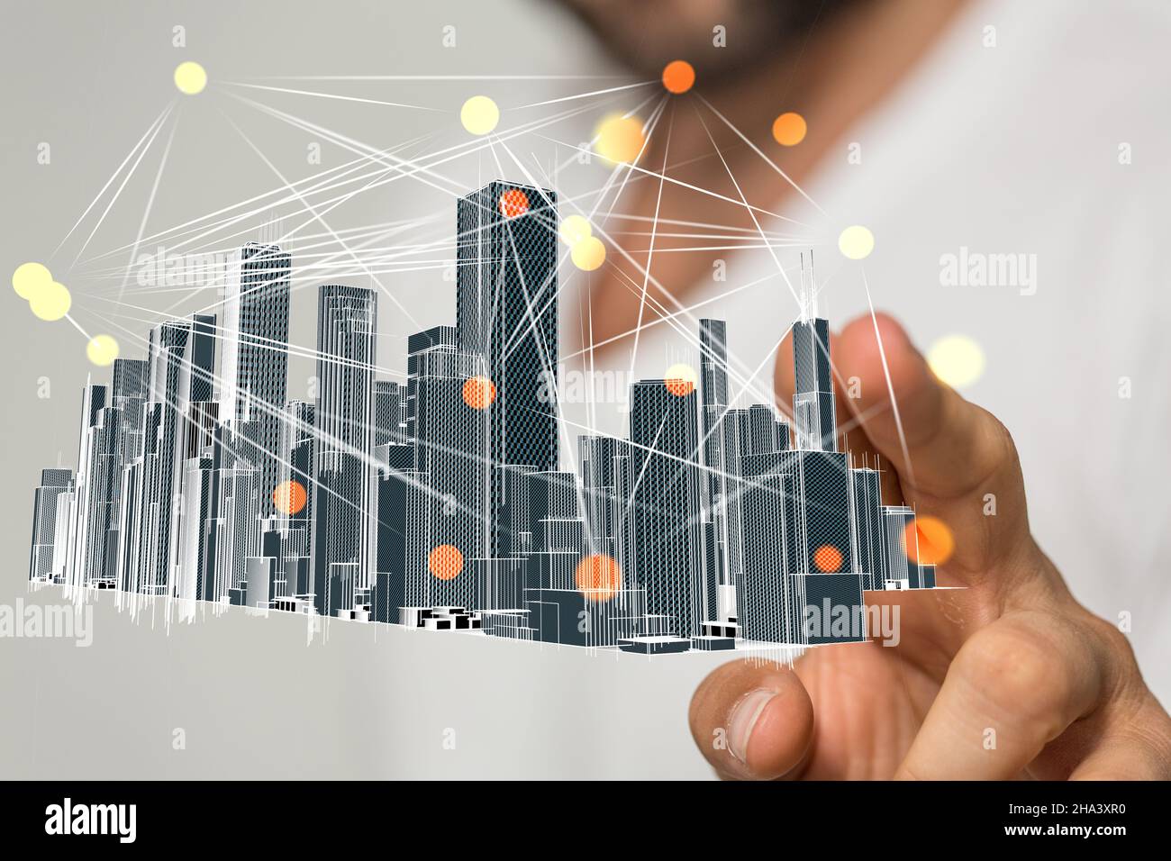 Businessman hovering a modern cityscape floating on his hand Stock Photo