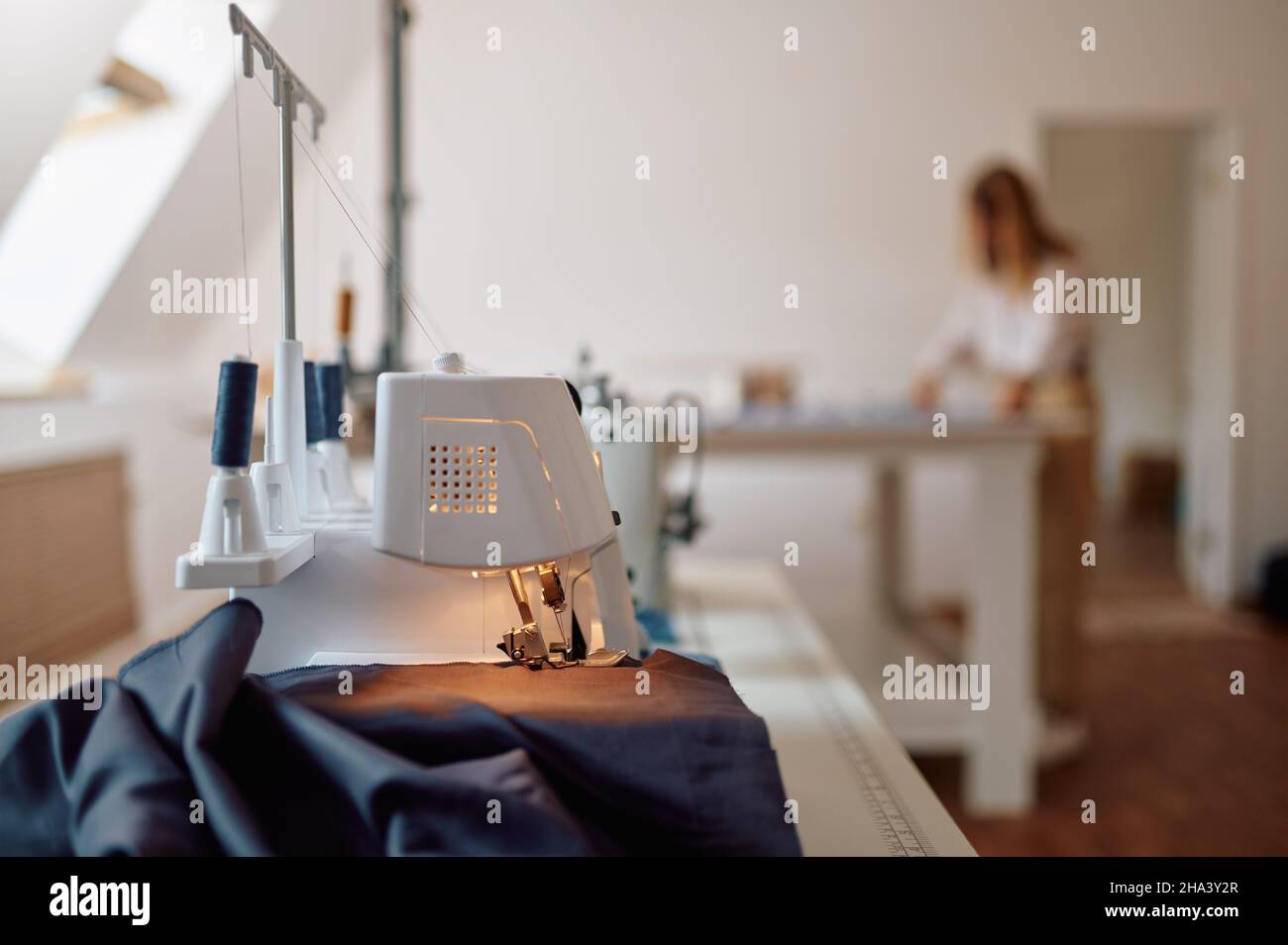 Sewing machine, seamstress works at the table Stock Photo Alamy