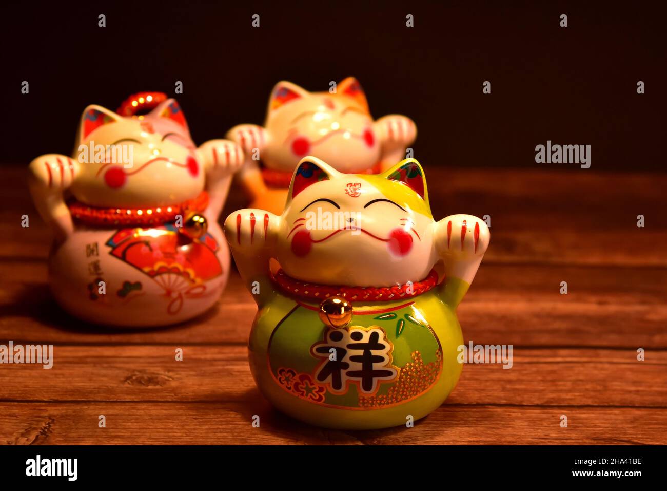 Japanese beckoning cats (manekineko) made of porcelain. They are traditional symbols for good luck. Stock Photo