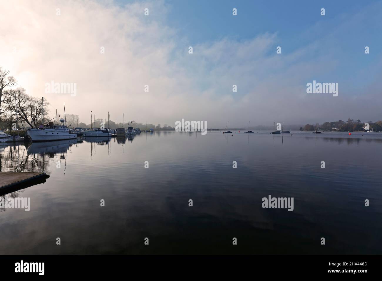 Oulton broad at Dusk with mist and reflections on the water. Stock Photo