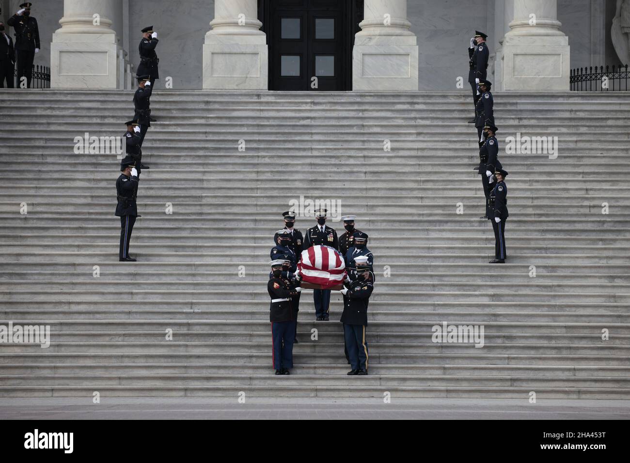 Washington, United States. 10th Dec, 2021. U.S. Capitol Police Officers stand at attention as Senate Sergeant at Arms Karen Gibson (R) and House Sergeant at Arms William J. Walker (L) lead a joint services military honor guard as they carry the casket of the late Sen. Robert Dole (R-KS) down the steps of the U.S. Capitol after lying in state on December 10, 2021 in Washington, DC. Pool Photo by Anna Moneymaker/UPI Credit: UPI/Alamy Live News Stock Photo