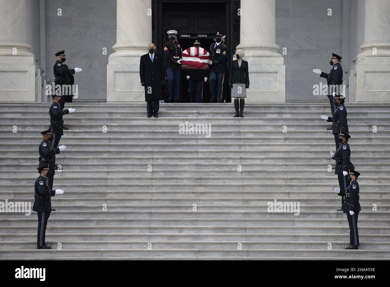 Washington, United States. 10th Dec, 2021. U.S. Capitol Police Officers stand at attention as Senate Sergeant at Arms Karen Gibson (R) and House Sergeant at Arms William J. Walker (L) lead a joint services military honor guard as they carry the casket of the late Sen. Robert Dole (R-KS) down the steps of the U.S. Capitol after lying in state on December 10, 2021 in Washington, DC. Pool Photo by Anna Moneymaker/UPI Credit: UPI/Alamy Live News Stock Photo