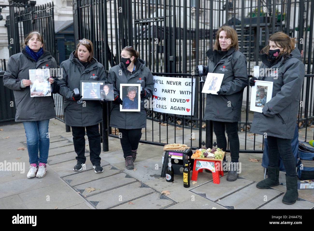 London, UK. 10th Dec, 2021. Members of 'Covid-19 Bereaved Families for Justice' who lost family members during lockdown provide cheese and wine at the gates of Downing Street for passers by as a protest against the parties allegedly held at Number 10 last year. Credit: Phil Robinson/Alamy Live News Stock Photo