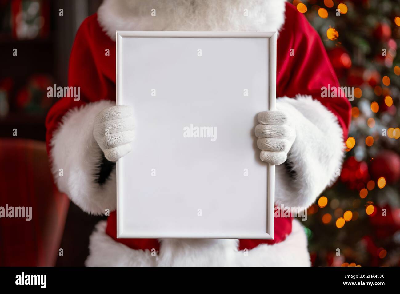 Santa Claus holding white frame in his hands Stock Photo - Alamy