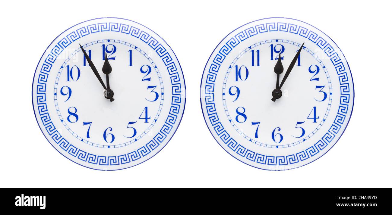 antique clock with five to twelve and five to twelve isolated on a white background Stock Photo