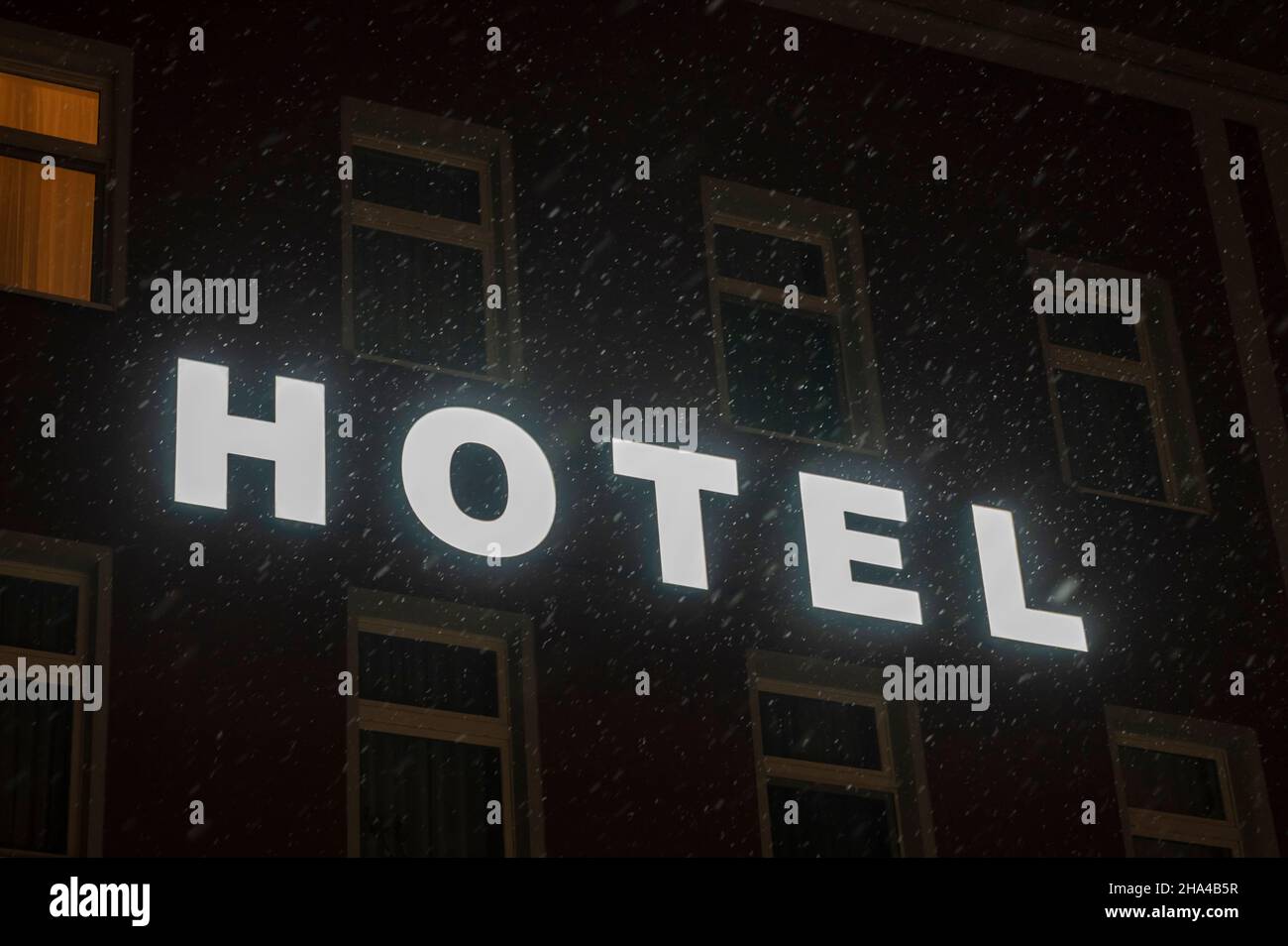 Writing hotel on a house wall during snowfall Stock Photo