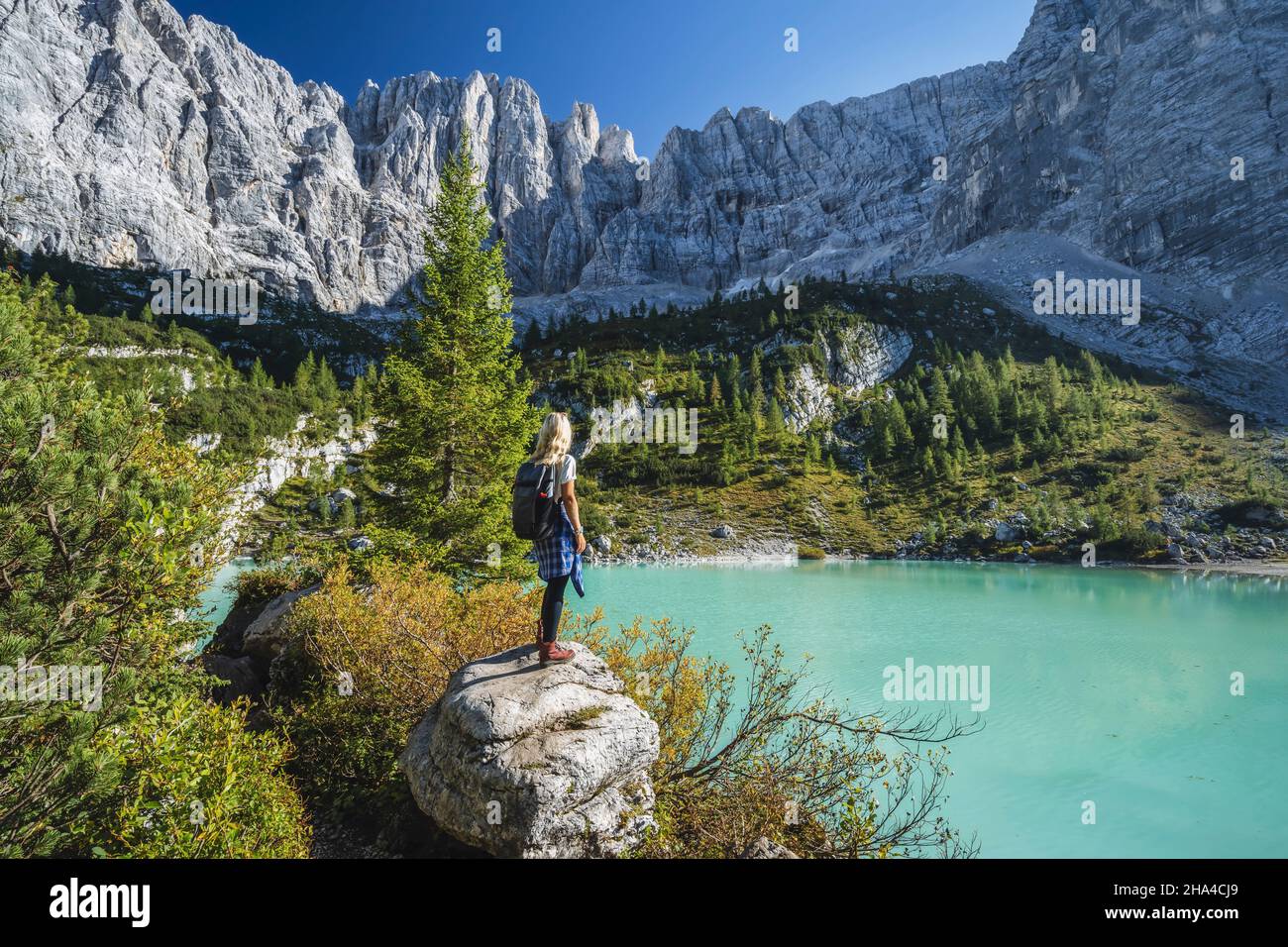 woman hiker enjozing beautifulturquoise mountain sorapiss lake in dolomites,italy. Stock Photo