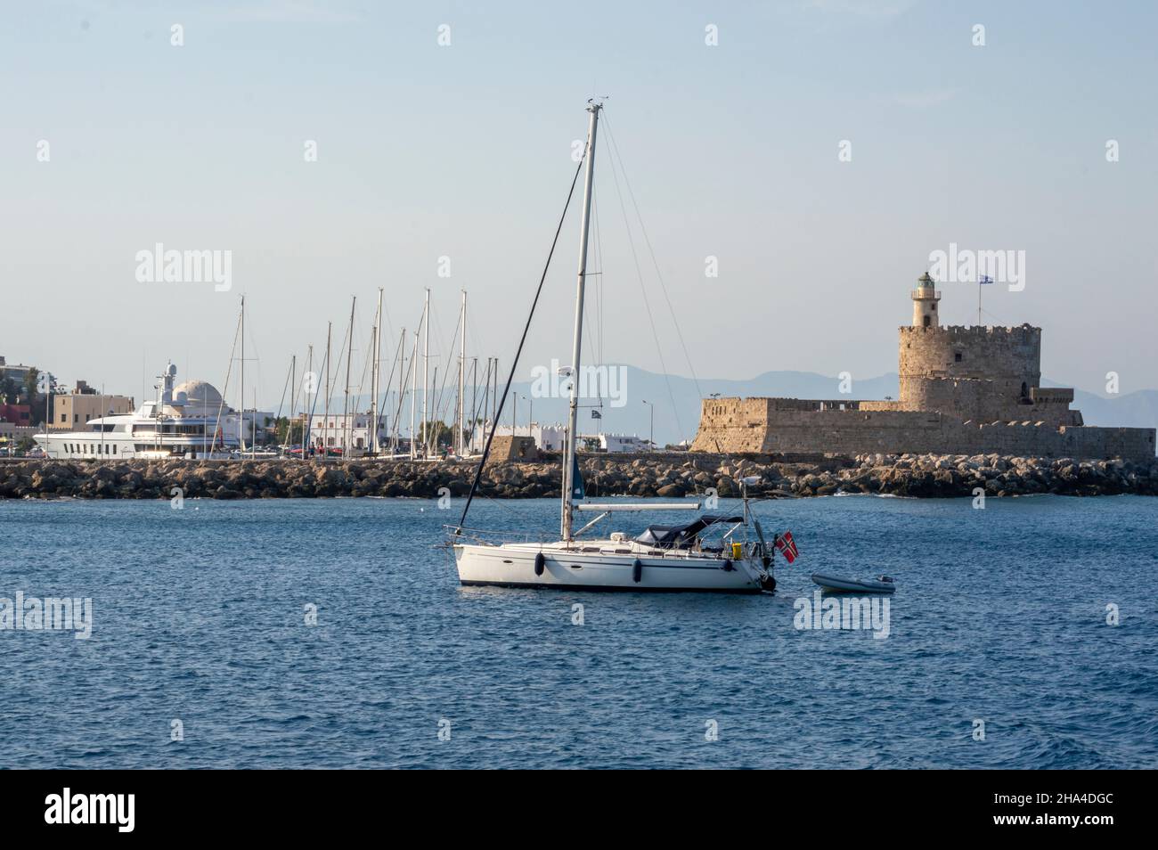 White boat sailing close to the coast blue aegean sea in Greece Stock ...