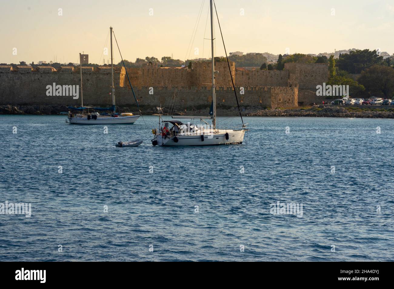 White boat sailing close to the coast blue aegean sea in Greece Stock ...