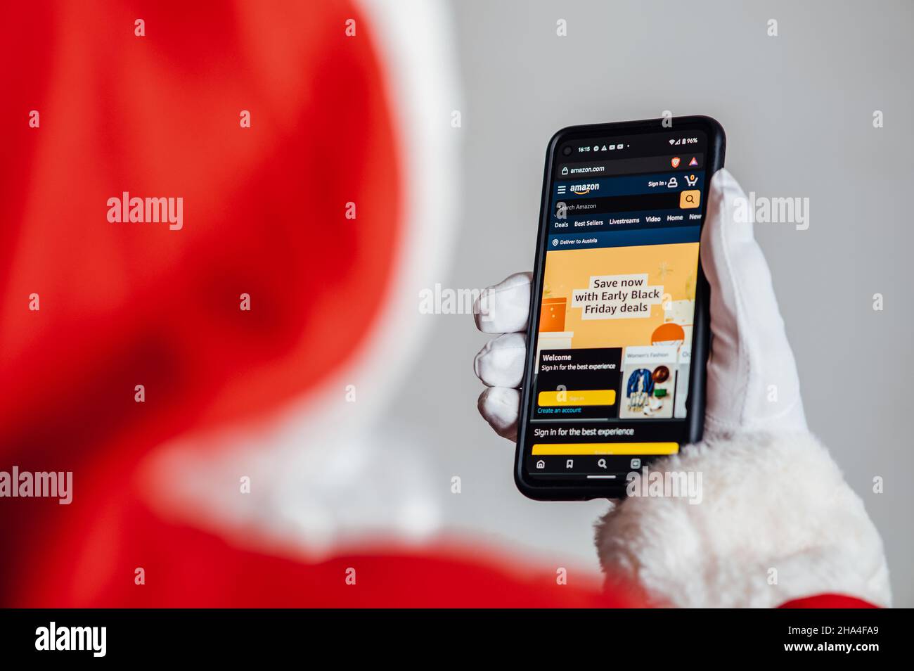 Santa browsing online store looking for Black Friday deals Stock Photo