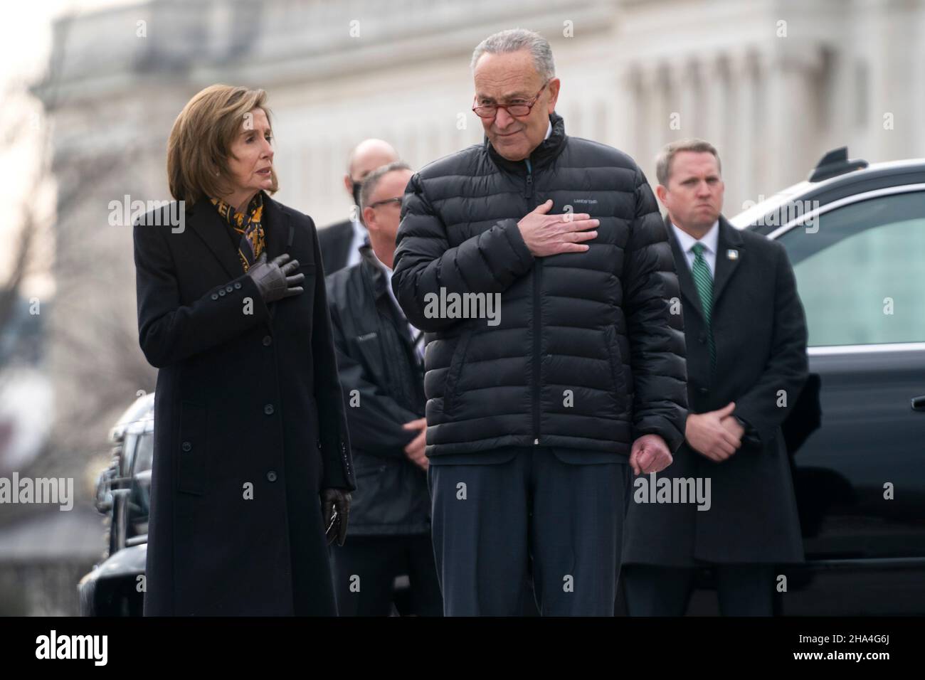 Washington, USA. 10th Dec, 2021. Speaker Nancy Pelosi (D-Calif.) and House Majority Leader Charles Schumer (D-N.Y.) watch a military honor guard carries the casket of Sen. Bob Dole (R-Kan.) after lying in state at the U.S. Capitol in Washington, DC, on Friday, December 10, 2021. Dole will be taken to Washington National Cathedral for a funeral service. (Photo by Greg Nash/Pool/Sipa USA) Credit: Sipa USA/Alamy Live News Stock Photo