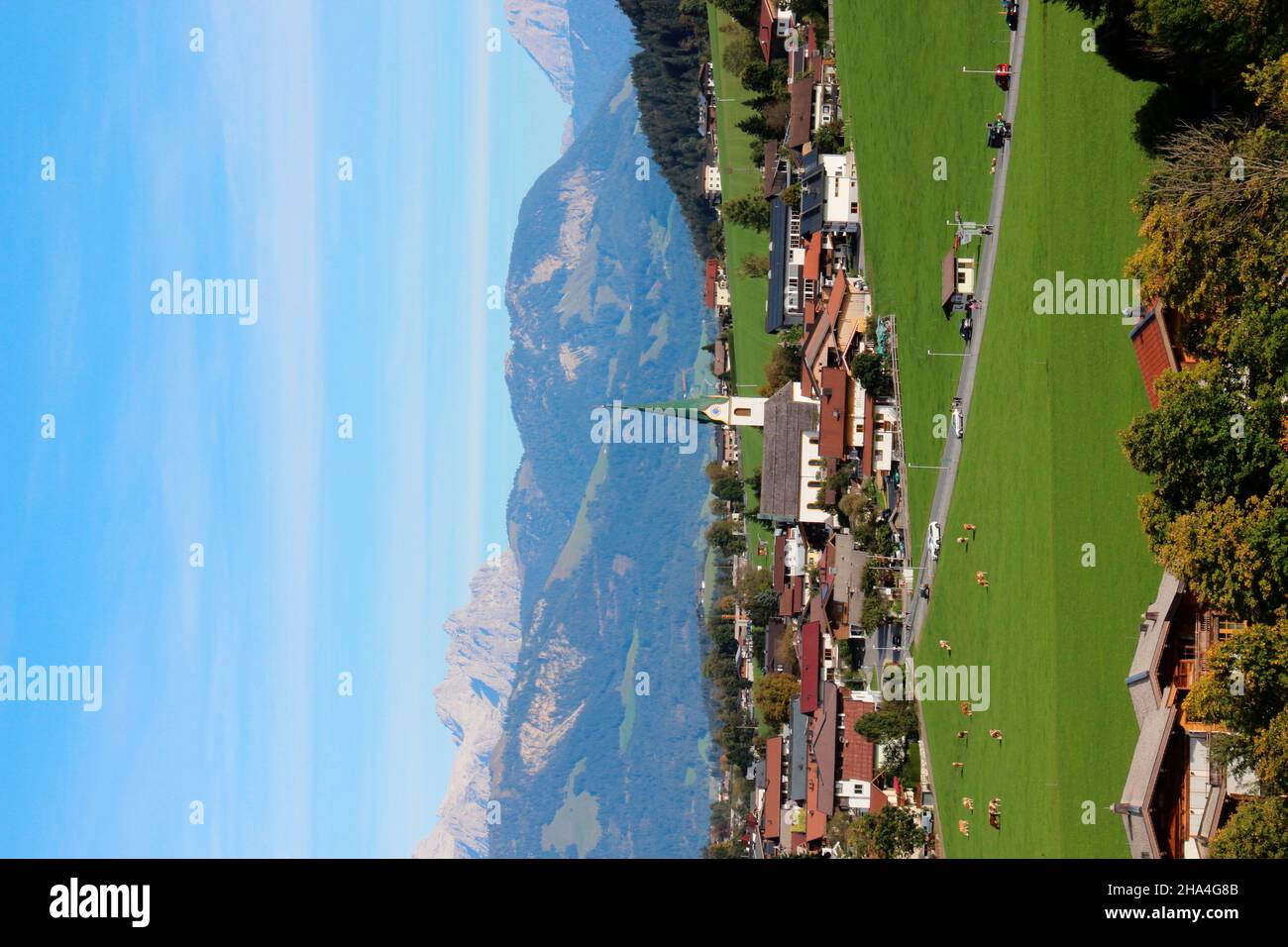 austria,tyrol,kaiser mountains,ellmau,place view,place,place overview,landscape,nature,alps,mountains,mountain range,alpine region,meadow,forest,green,travel destination,holiday region,church,steeple,sky,blue Stock Photo