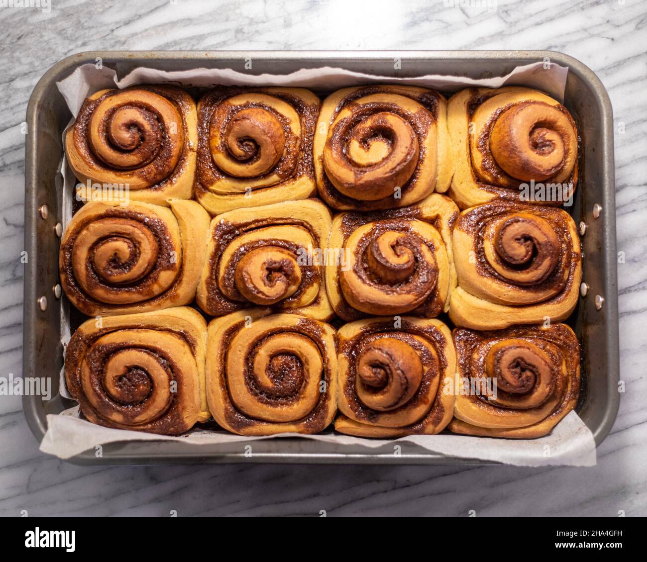 Baked Pumpkin Cinnamon Rolls in a Tray Stock Photo