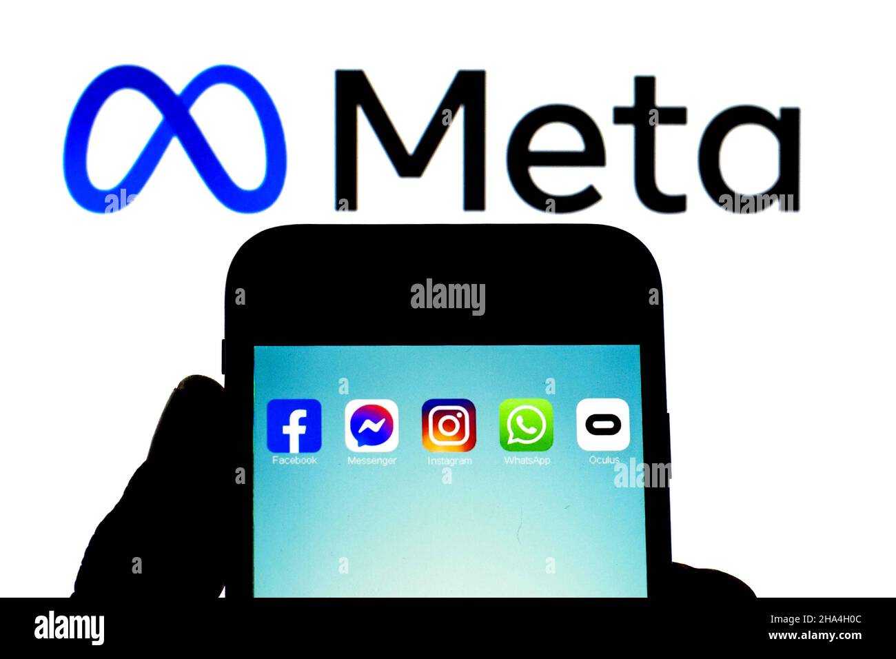 In this photo illustration the app icons of Facebook, Messenger, Instagram,  WhatsApp and Oculus VR seen displayed on a smartphone with a Meta logo in  the background. (Photo by Thiago Prudencio /