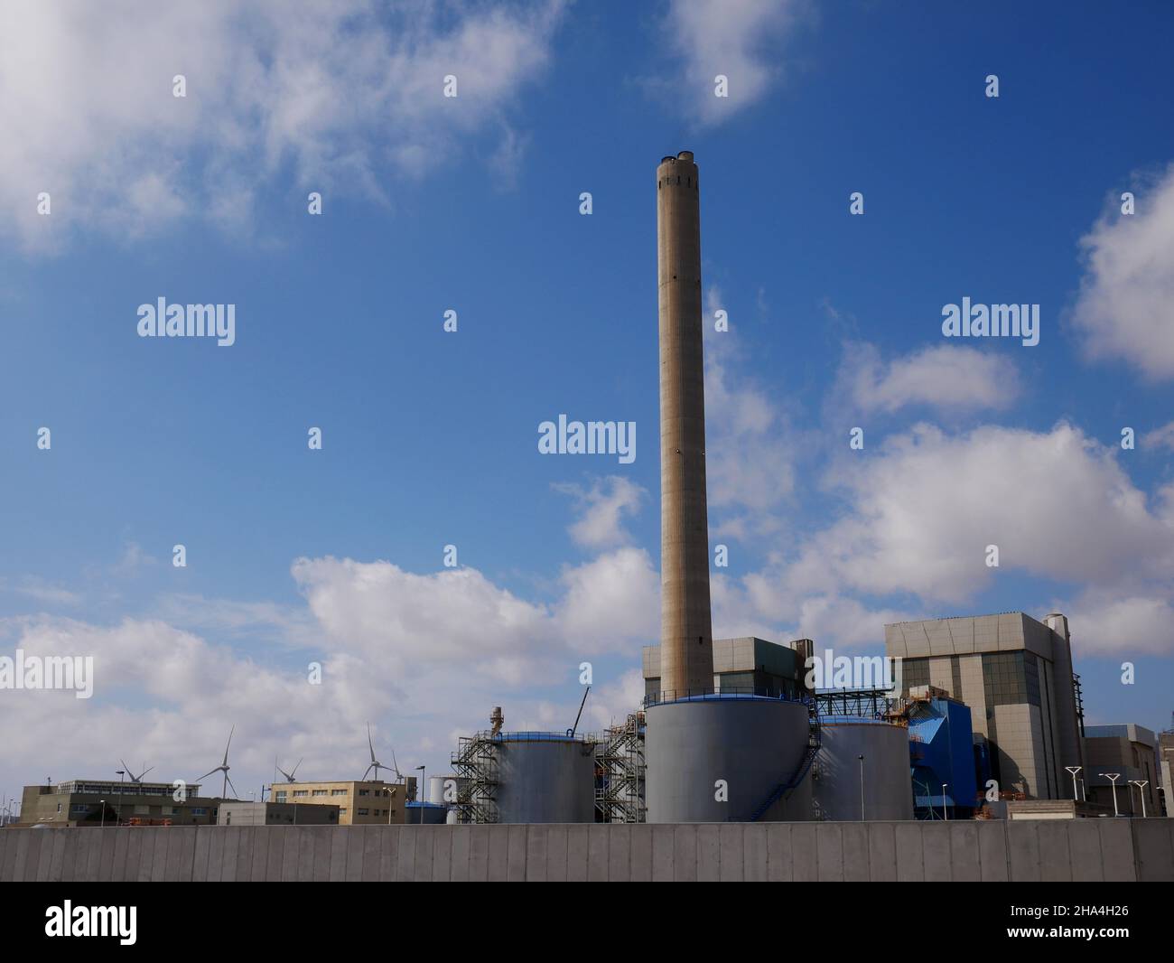 Industrial complex with blue sky and clouds Stock Photo