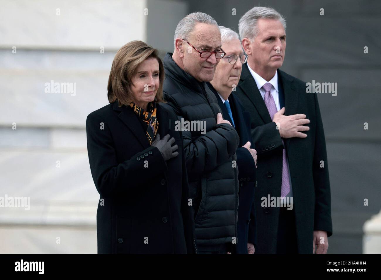 WASHINGTON, DC - DECEMBER 10: Speaker of the House Nancy Pelosi (D-CA), Majority Leader Charles Schumer (D-NY), Minority Leader Mitch McConnell (R-KY) and House Minority Leader Kevin McCarthy (R-CA) watch as joint services military honor guard carries the casket of the late Sen. Robert Dole (R-KS) down the steps of the U.S. Capitol after lying in state on December 10, 2021 in Washington, DC. Dole, a veteran who was severely injured in World War II, was a Republican Senator from Kansas from 1969 to 1996. He ran for president three times and became the Republican nominee for president in 1996. ( Stock Photo