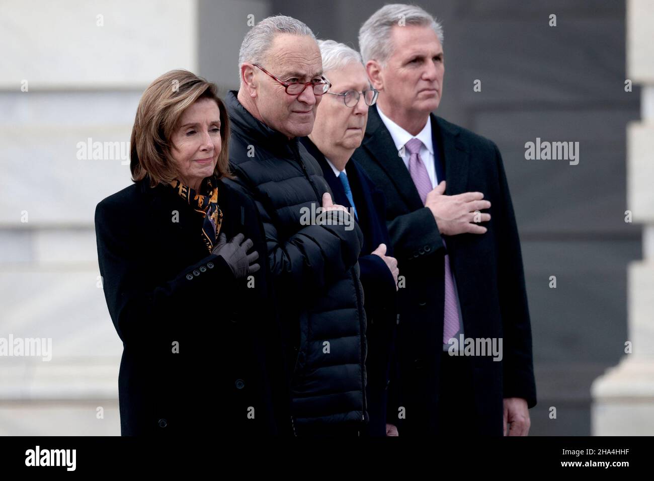 WASHINGTON, DC - DECEMBER 10: Speaker of the House Nancy Pelosi (D-CA), Majority Leader Charles Schumer (D-NY), Minority Leader Mitch McConnell (R-KY) and House Minority Leader Kevin McCarthy (R-CA) watch as joint services military honor guard carries the casket of the late Sen. Robert Dole (R-KS) down the steps of the U.S. Capitol after lying in state on December 10, 2021 in Washington, DC. Dole, a veteran who was severely injured in World War II, was a Republican Senator from Kansas from 1969 to 1996. He ran for president three times and became the Republican nominee for president in 1996. ( Stock Photo