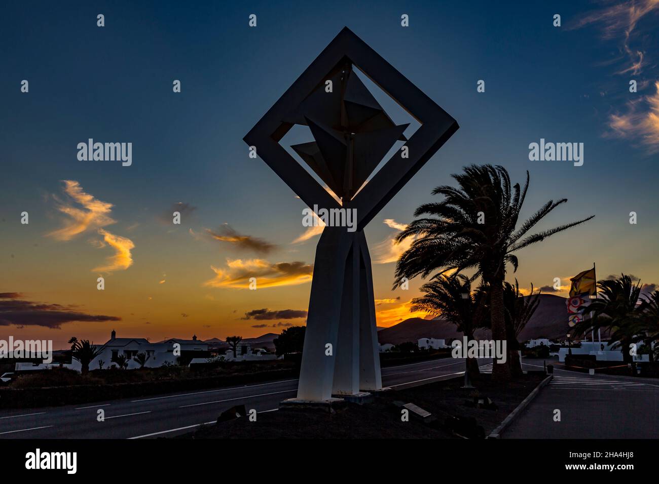 wind chimes in front of the fundacion cesar manrique at sunset