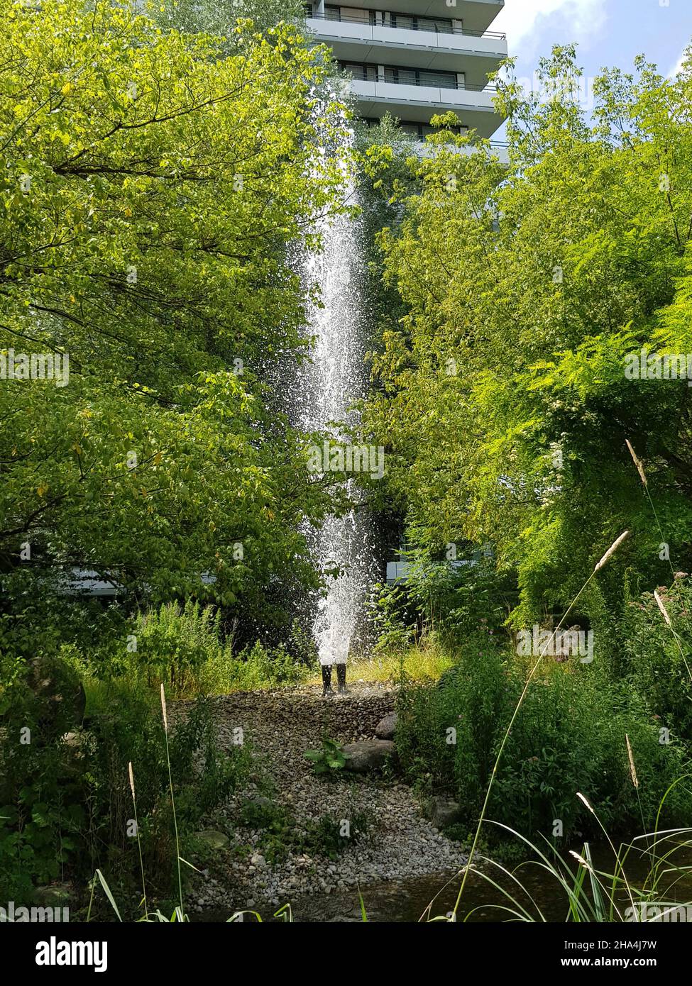 petuelpark,districts of schwabing / milbertshofen,laid out above the petuel tunnel,opened june 22,2004. work of art: a 7 m high fountain shoots out of a pair of rubber boots,artist: roman signer Stock Photo