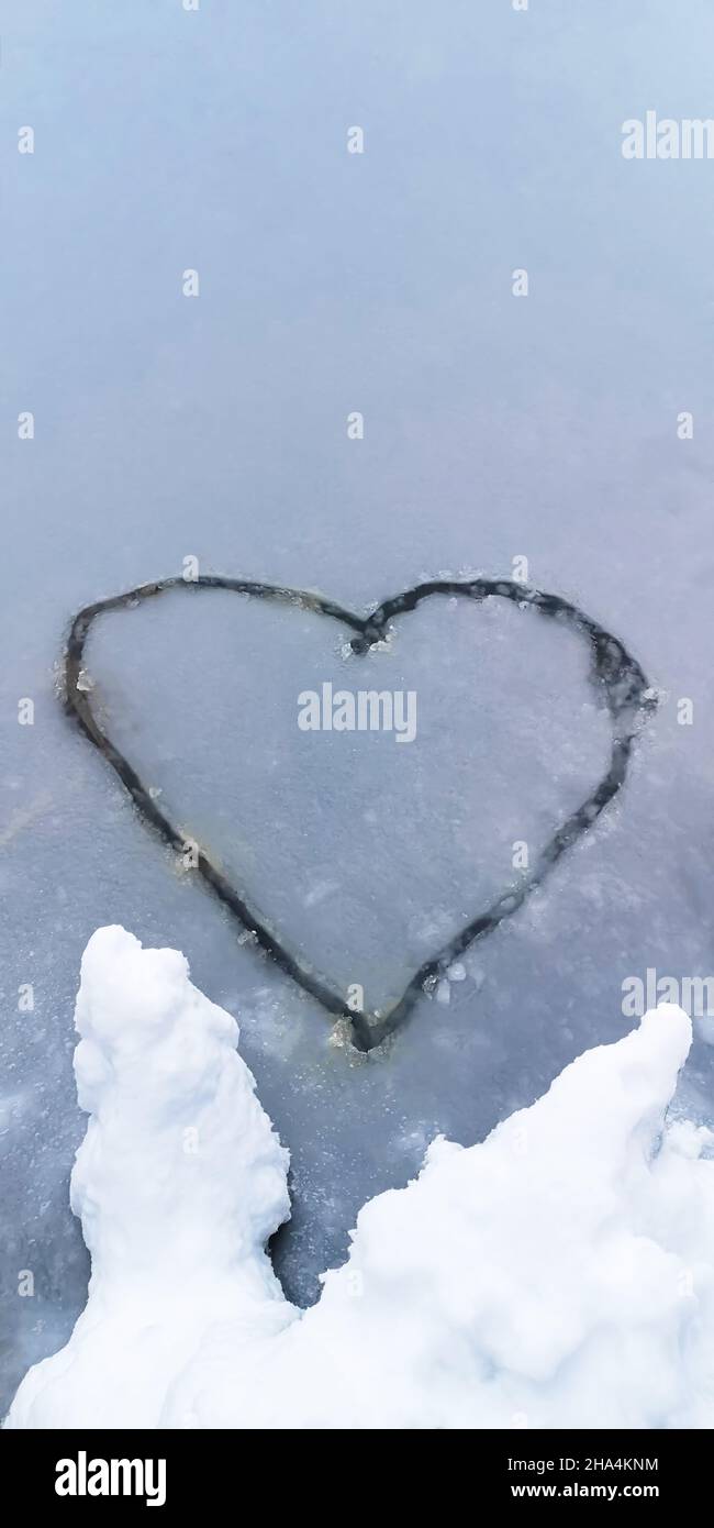 Heart-shaped drawing on an ice-covered lake in winter Stock Photo