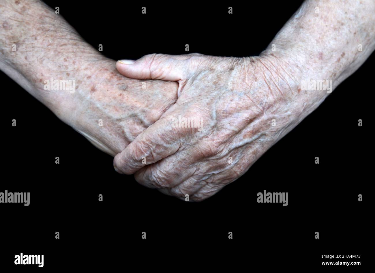 Aging process - very old senior woman hands isolated on black ...