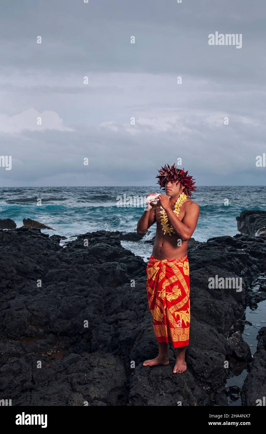 A Hawaiian native with conch shell in Hana, Maui Stock Photo