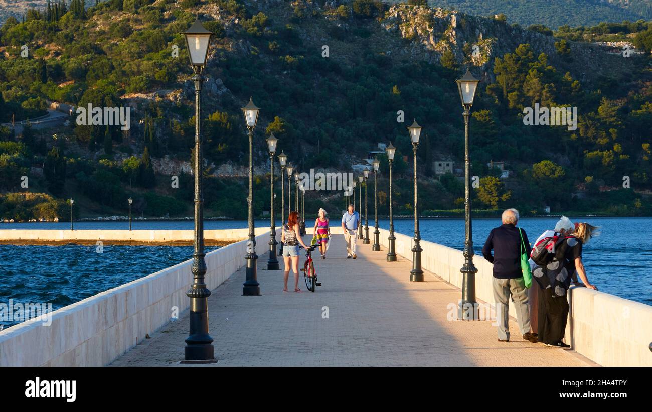greece,greek islands,ionian islands,kefalonia,argostoli,capital of kefalonia,de bosset bridge,passers-by on bridge,left and right lanterns Stock Photo
