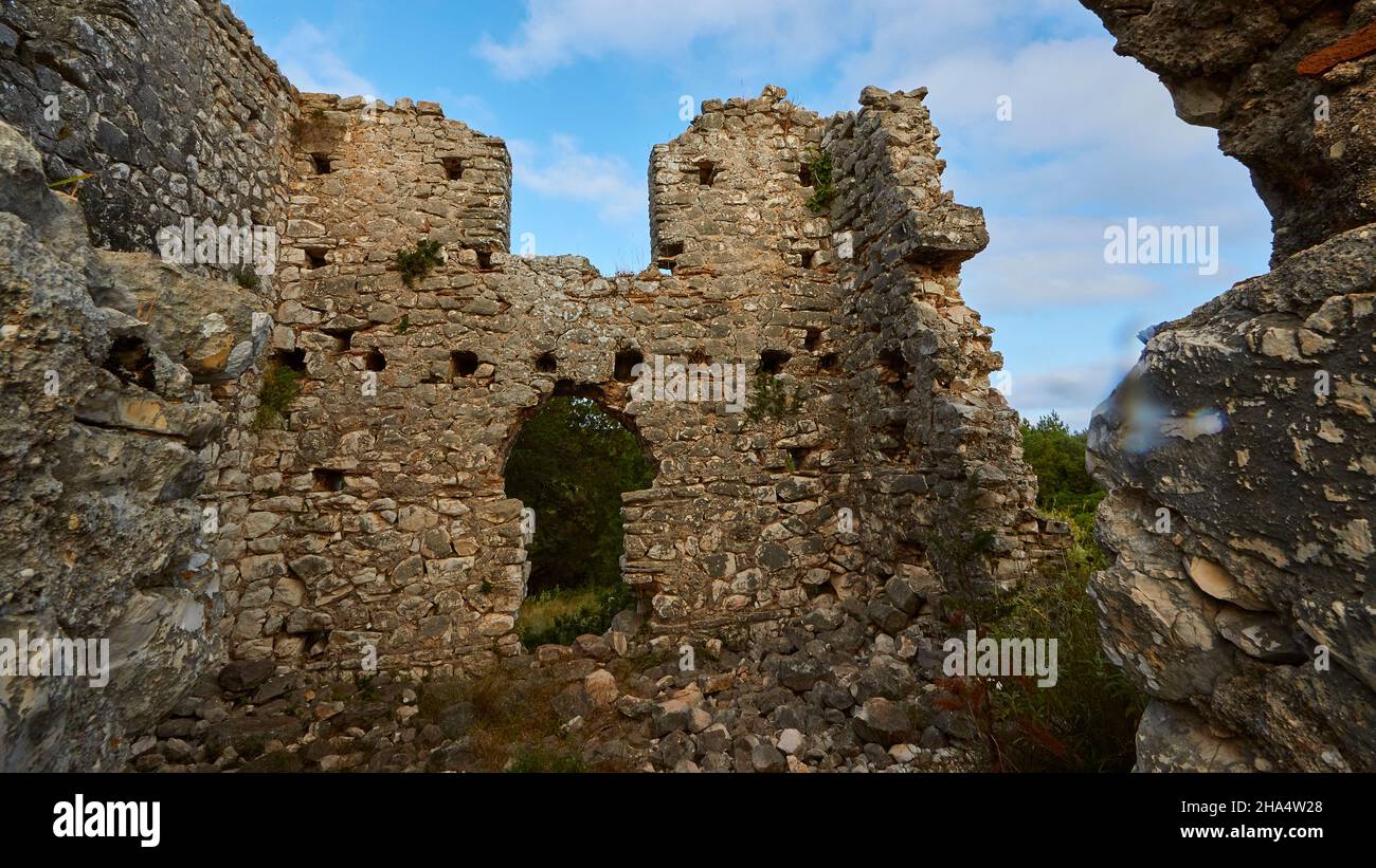 greece,greek islands,ionian islands,kefalonia,fiskardo,morning mood,partly cloudy sky,eastern headland,building ruin inside,looking up at ruined walls and the blue sky with white clouds Stock Photo