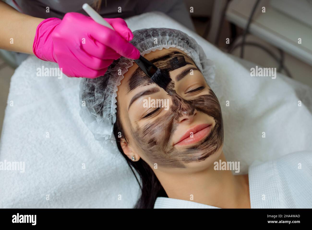 Close-up of carbon peeling procedure for middle-aged woman face. Laser pulses clean skin. Process of photothermolysis, warming, laser carbon peeling Stock Photo