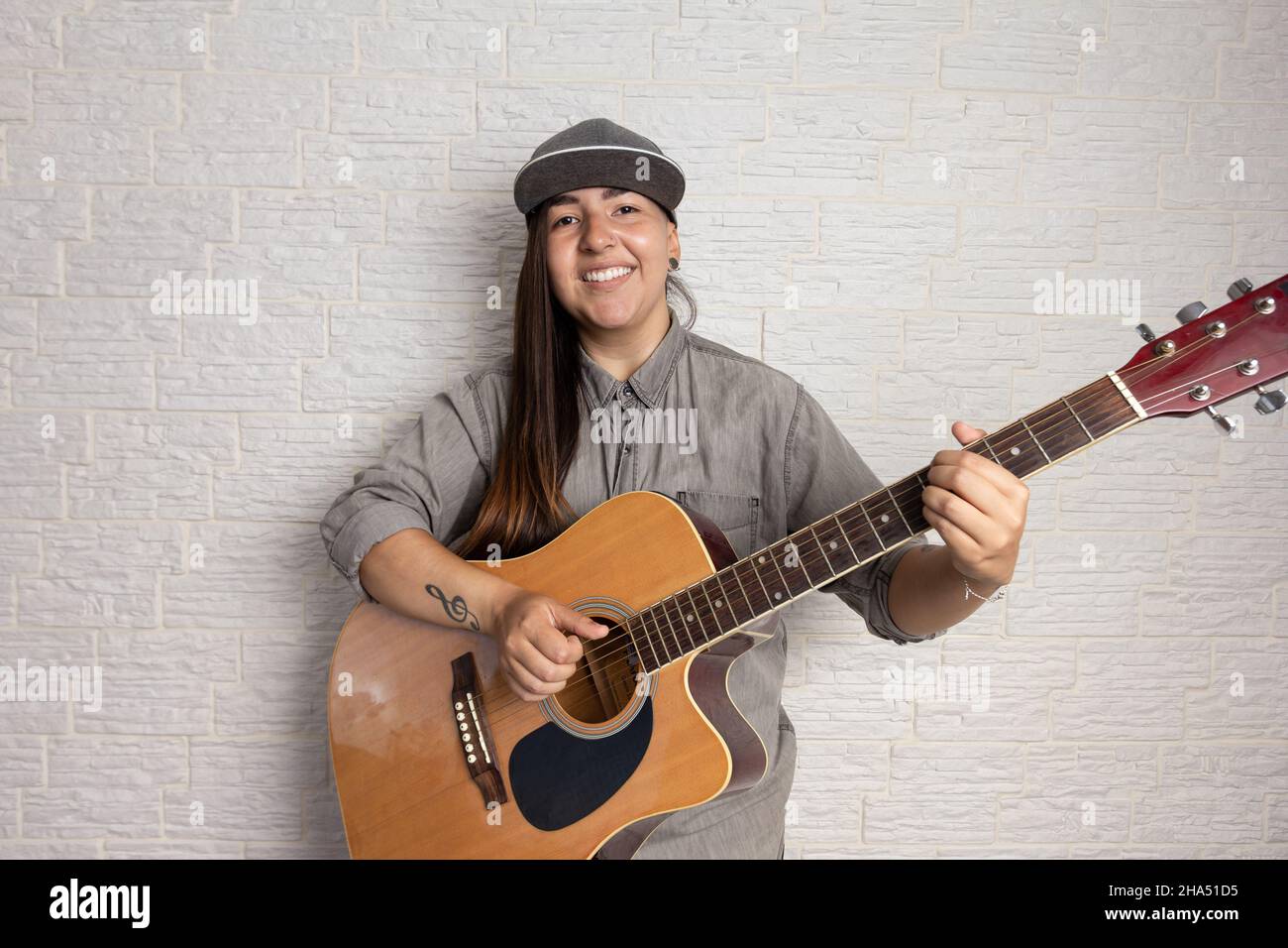 Trendy girl with unusual hairstyle posing for photo with acoustic guitar and tattoo Stock Photo - Alamy Trendy girl with unusual hairstyle posing for photo with acoustic guitar and tattoo Stock Photo - Alamy