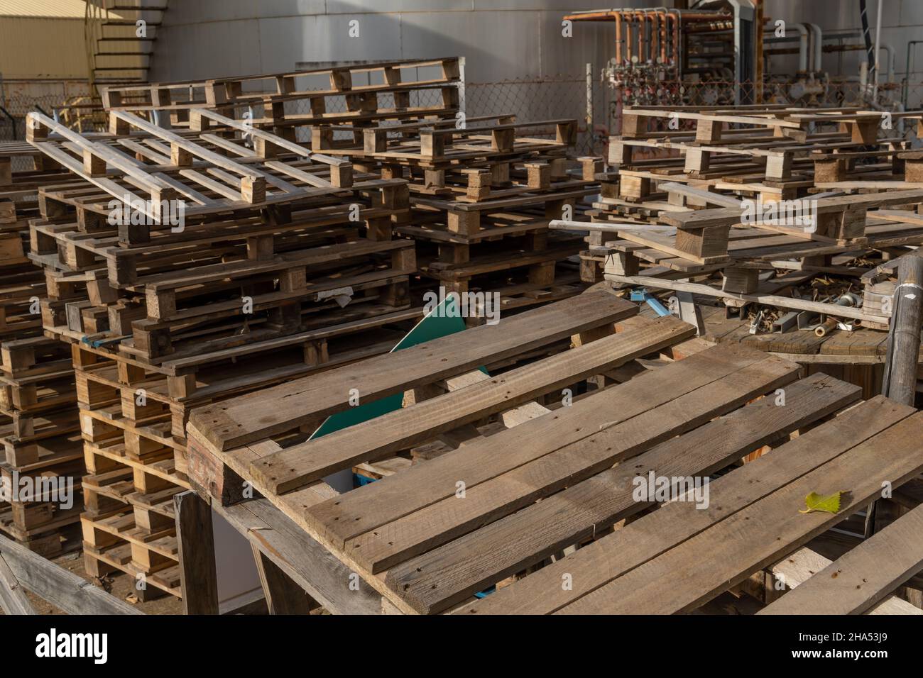 Wooden pallets irregularly stacked on an industrial park in Spain Stock