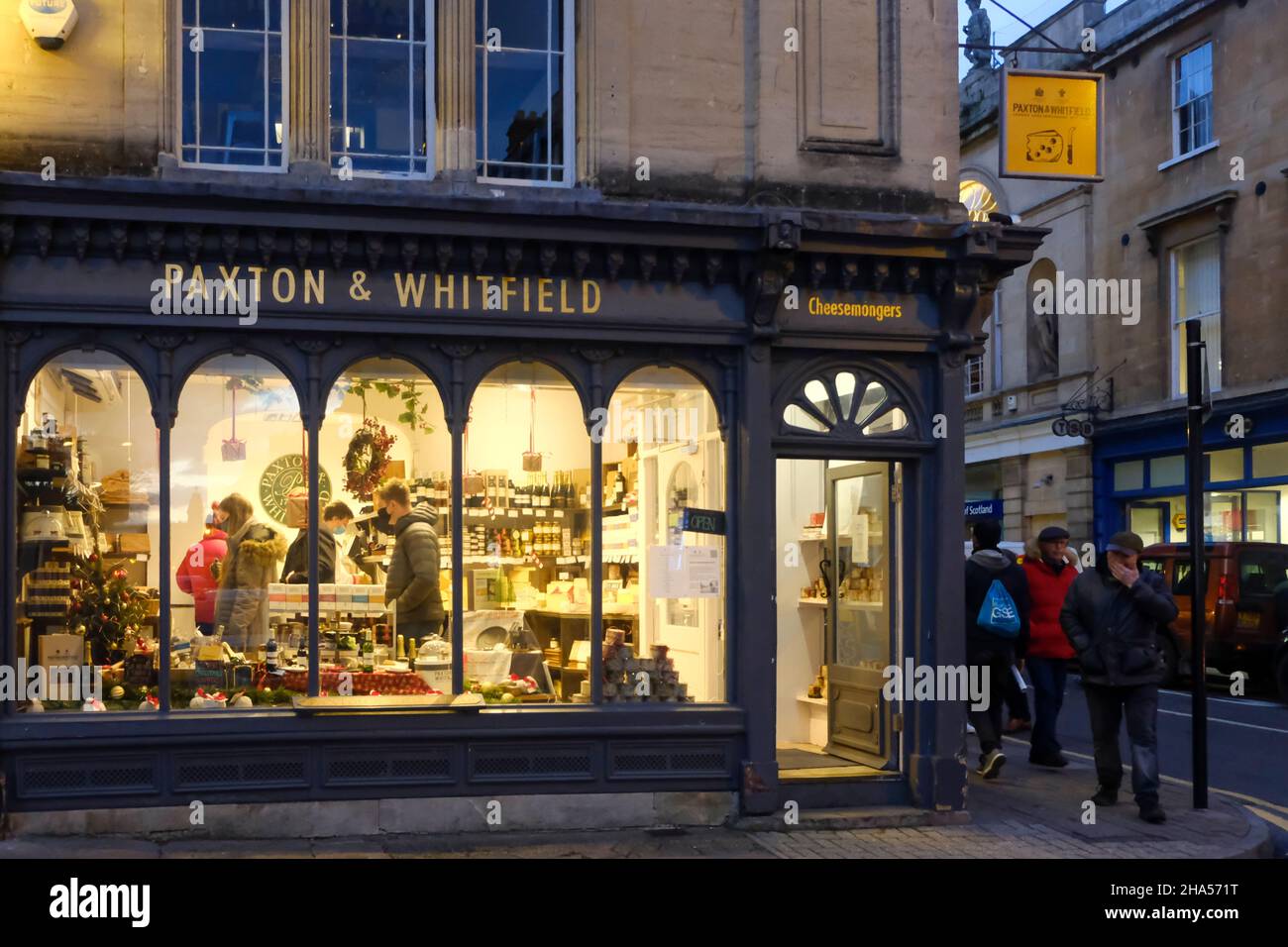 Bath, 10th December 2021. People do their Pre-Christmas shopping in Bath city centre as concerns over the Omicron Covid-19 variant rise. The Paxton and Whitfield cheese shop. Some people are wearing masks outside and some are not. Credit: JMF News/Alamy Live News Stock Photo