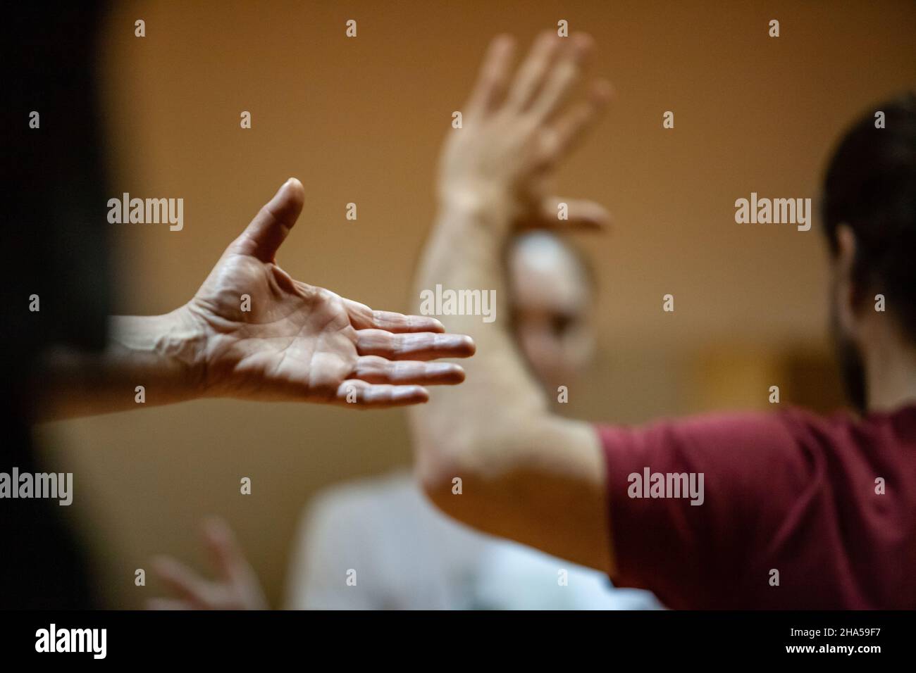 opened palm on blurred bg of moving performers dancer hand, dance performance improvisation Stock Photo