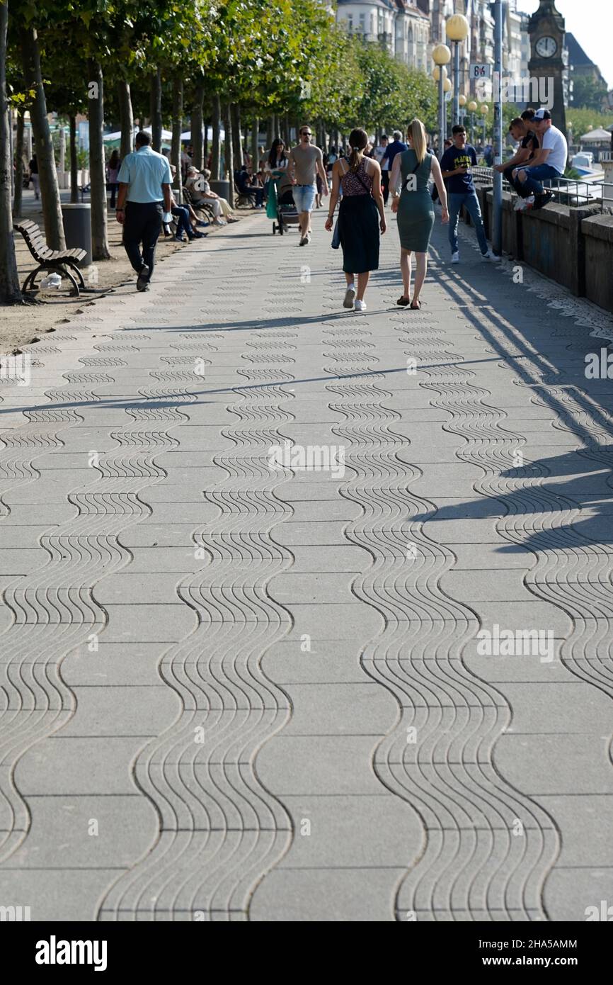 germany,north rhine-westphalia,dusseldorf,rhine promenade,pavement,wave coverings,passers-by,young people,chilling Stock Photo