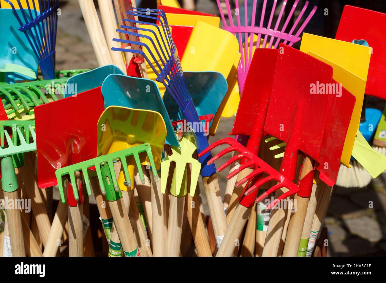 colorful rakes and shovels on a market stall,germany Stock Photo - Alamy