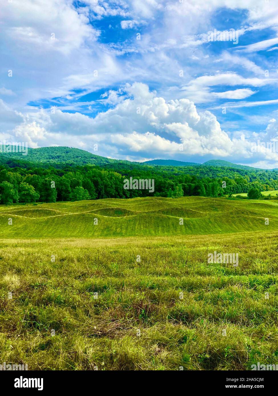 storm king art center,new windsor,ny. 'wavefield' earth sculpture by maya lin corresponds with surring catskill mountains hills Stock Photo
