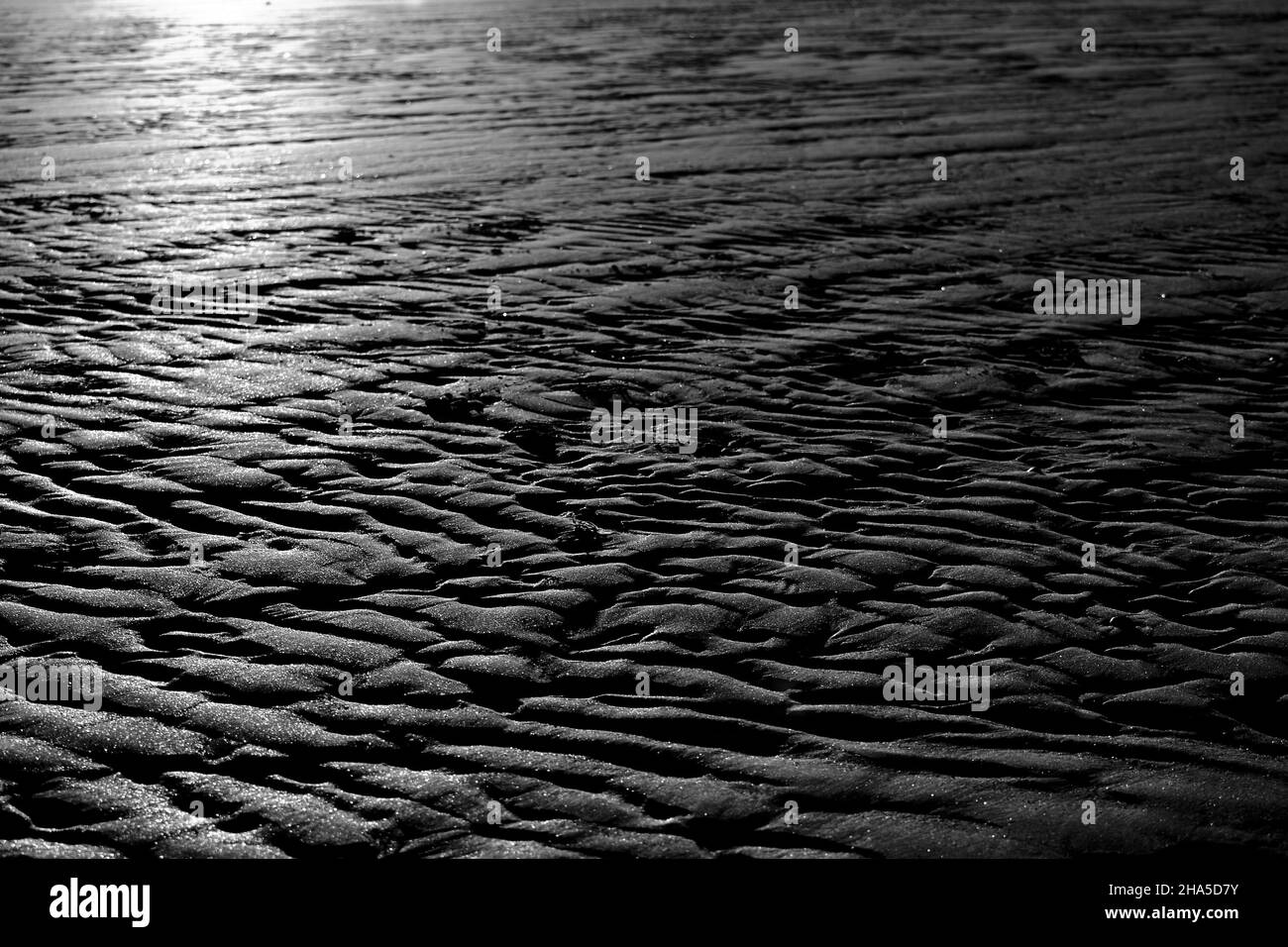 Stunning, naturally lit, B&W image showing naturally formed sand patterns on the North Yorkshire coast. Taken at South Gare, Redcar, Teesside, UK Stock Photo