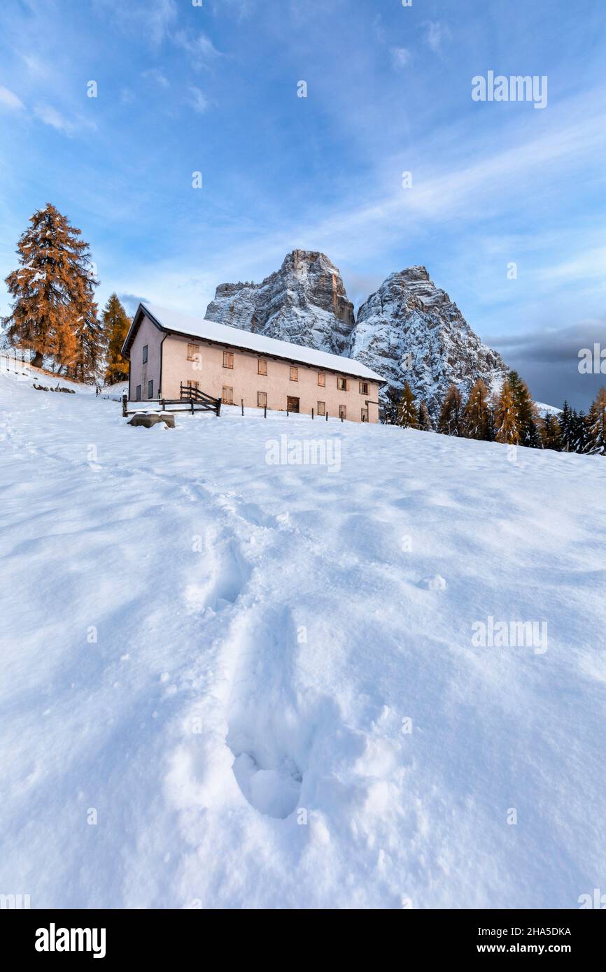 view of the fiorentina hut at the foot of mount pelmo with footprints on the first autumn snow,fiorentina valley,borca di cadore,belluno,veneto,italy Stock Photo