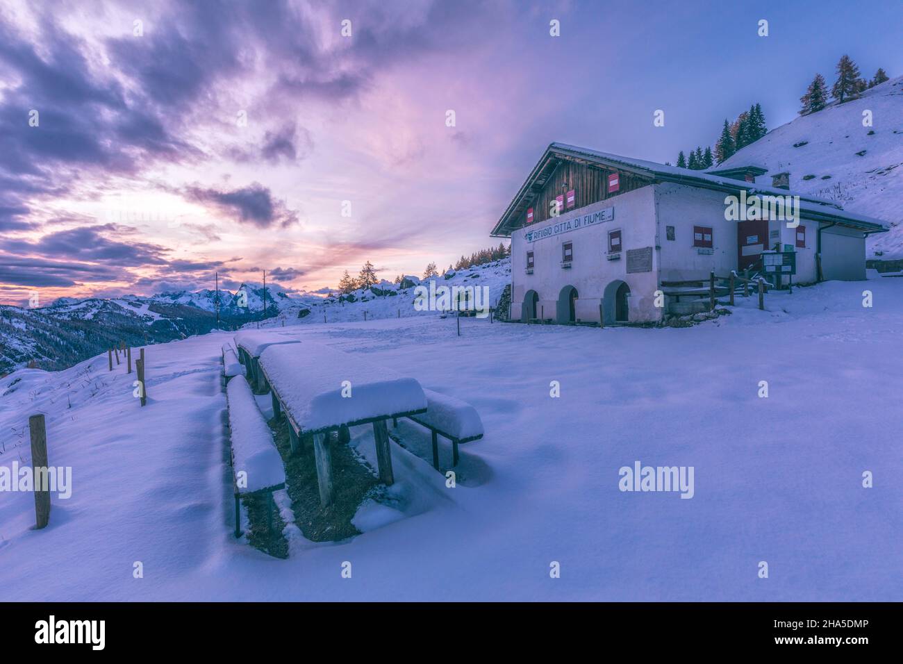 rifugio citta–€  di fiume,italian alpine hut in fiorentina valley at sunset in winter,borca di cadore,belluno,veneto,italy Stock Photo