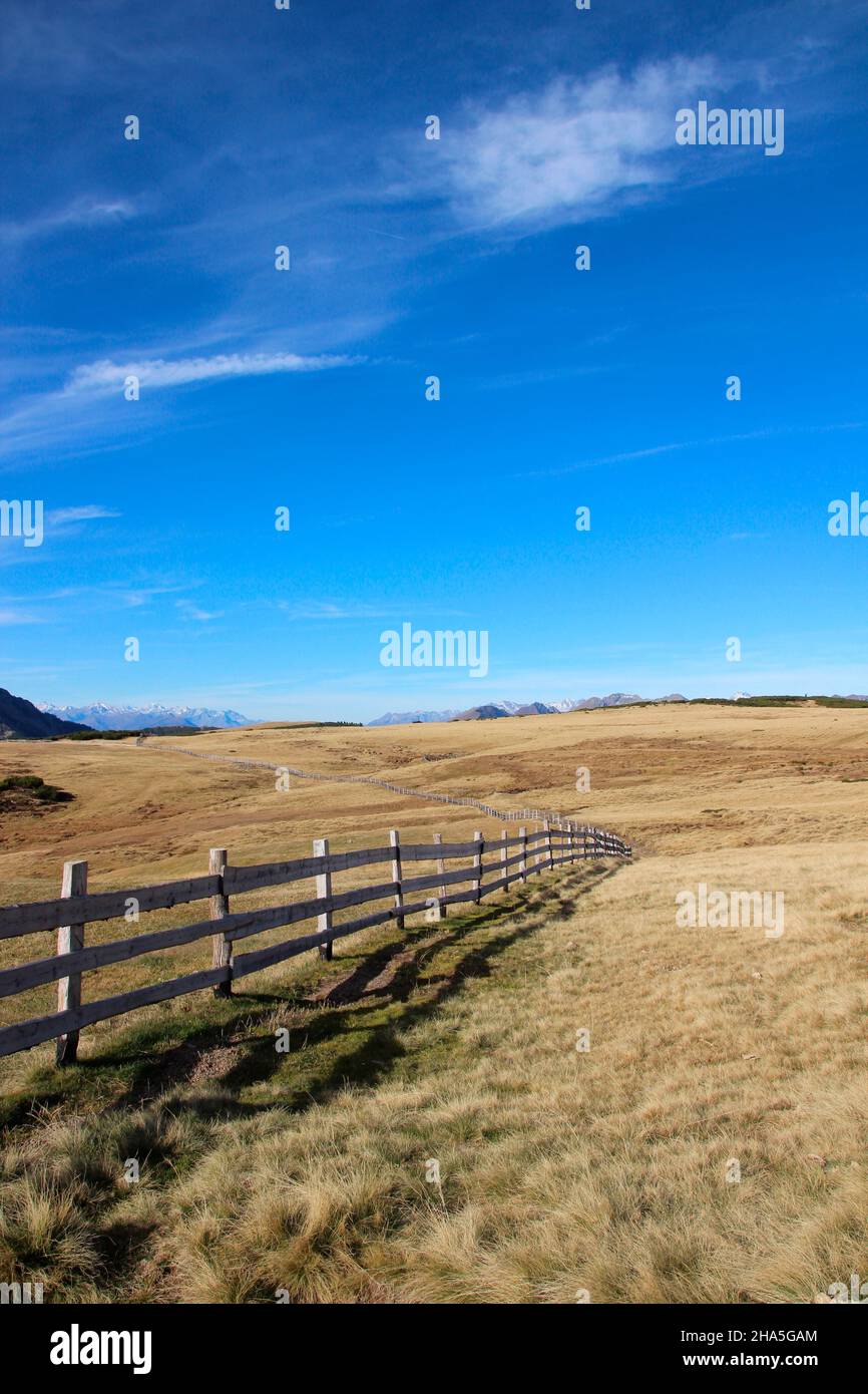 latzfons,klausen,bolzano province,south tyrol,italy,europe. hike to the shelter and pilgrimage church latzfonser kreuz,plateau,fence,in the background the foothills of the villanderer berg 2509 m,on the right small the ortler group, Stock Photo