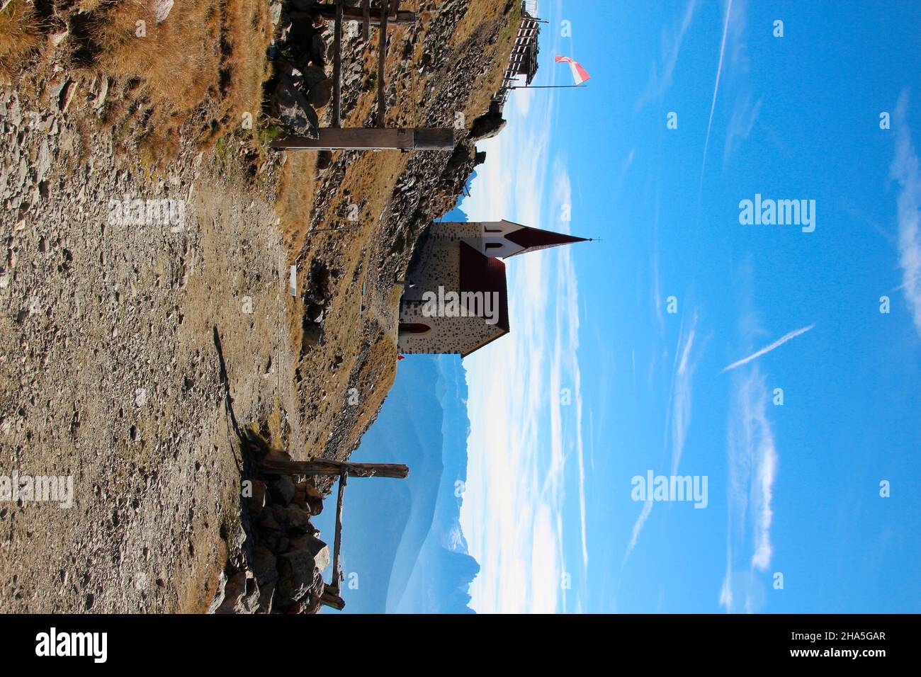 latzfons,sarntal alps,bolzano province,south tyrol,italy,europe. the shelter and the pilgrimage church latzfonser kreuz (2311m),to the right of the church the sella group next to the foothills of the langkofel group 3181 m,fence,gate,entrance gate,gate,access Stock Photo