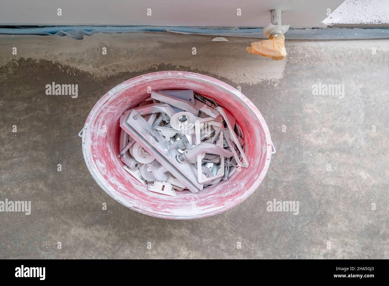 construction site,refurbishment and renovation of an apartment,buckets of full unscrewed door fittings and sockets Stock Photo
