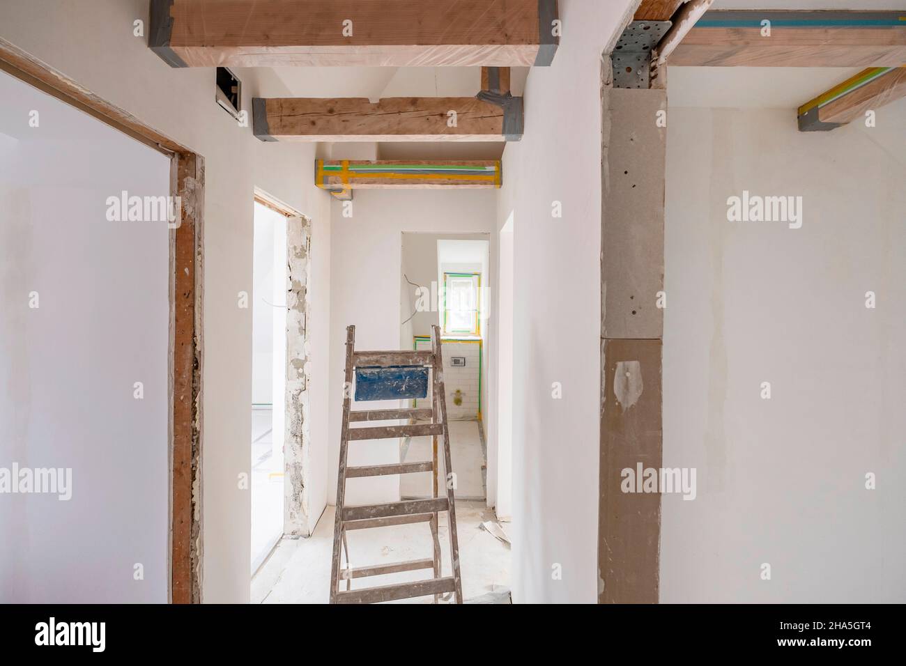 construction site,refurbishment and renovation of an apartment,empty hallway with wooden beam ceiling Stock Photo