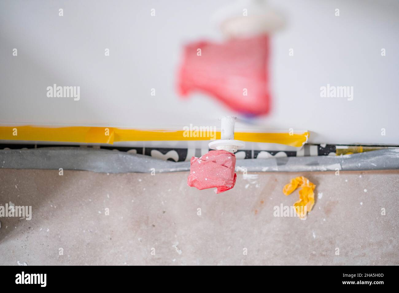 construction site,refurbishment and renovation of an apartment,masked heating pipes stick out of the wall Stock Photo