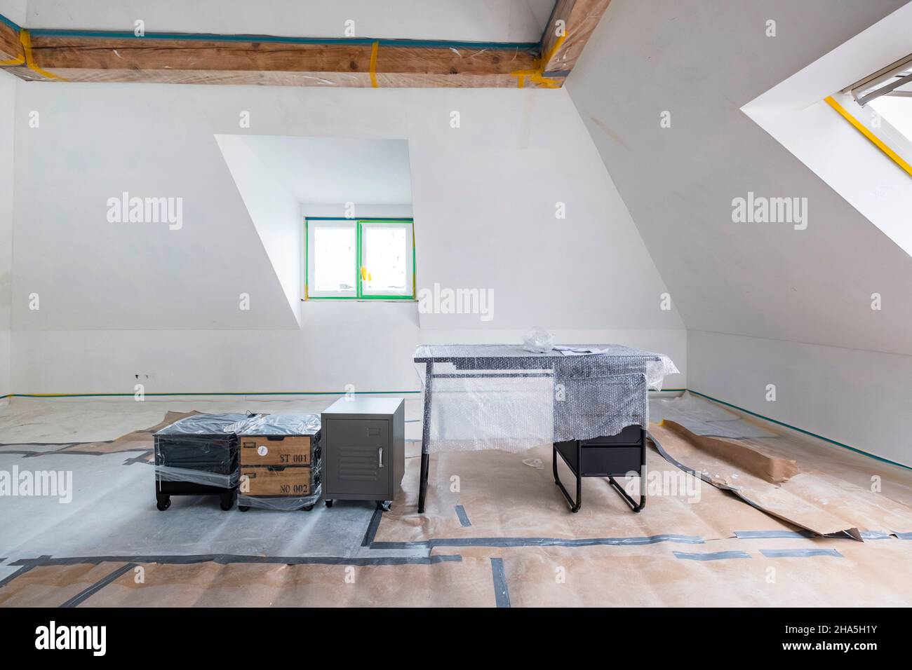 construction site,refurbishment and renovation of an apartment,bare room with covered furniture Stock Photo