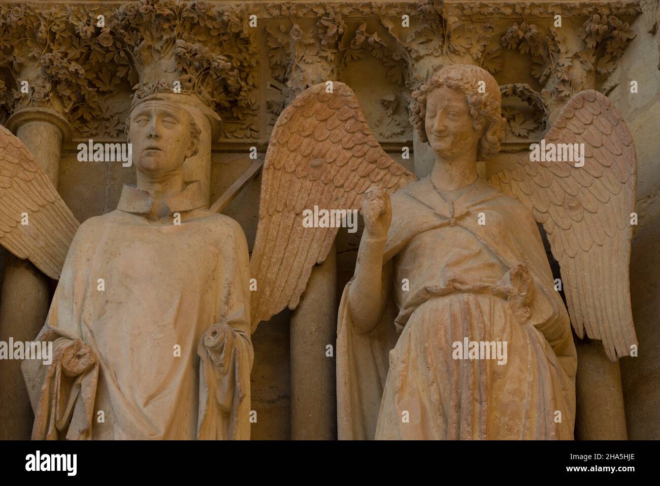 statues with a 'kind angel' figure,west facade,notre-dame cathedral,unesco world heritage site,reims,champagne,france Stock Photo